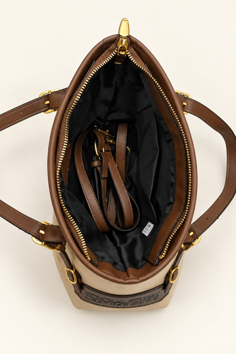Open black-lined interior of the Coach-branded replica Leatherware patch small tote bag