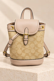 Beige Coach-branded replica monogram mini bucket backpack with light taupe trim and gold-tone hardware