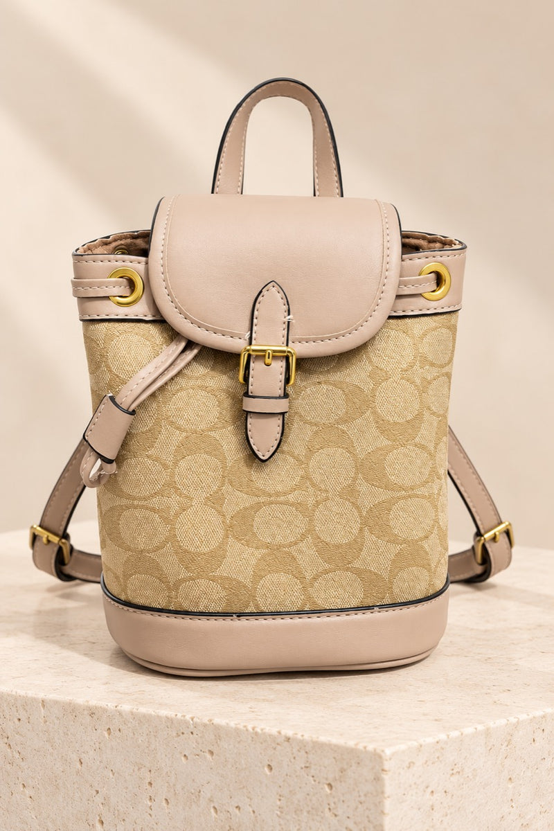 Beige Coach-branded replica monogram mini bucket backpack with light taupe trim and gold-tone hardware