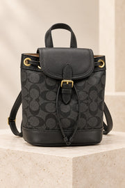 Black Coach-branded replica monogram mini bucket backpack with black trim and gold-tone hardware