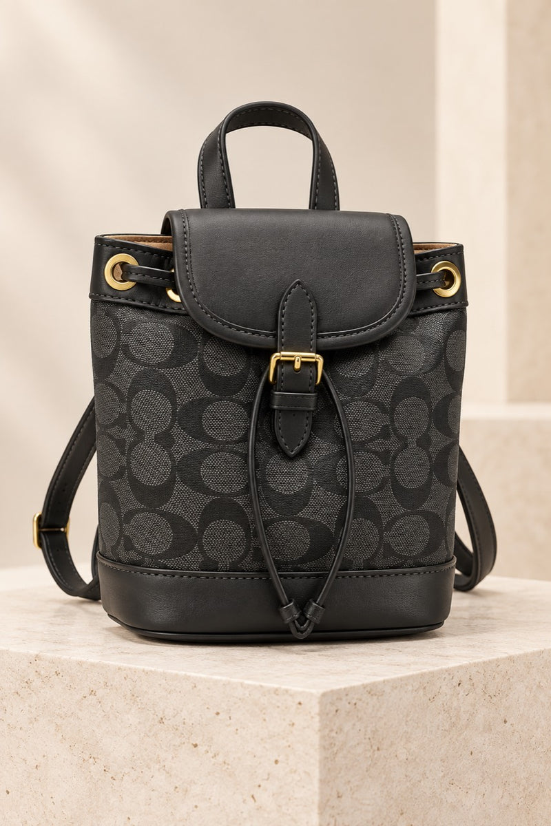Black Coach-branded replica monogram mini bucket backpack with black trim and gold-tone hardware