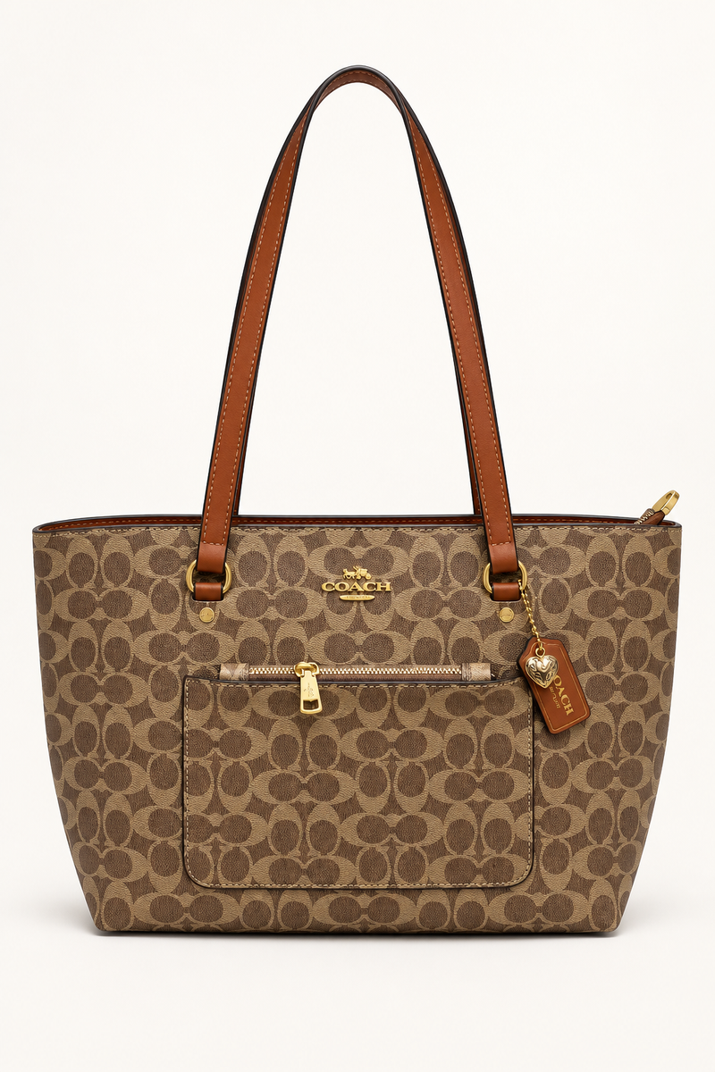 Dark brown Coach-branded replica monogram everyday tote bag with caramel straps and front zip pocket